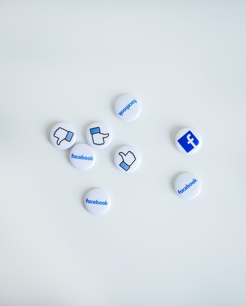 photo of facebook buttons and buttons with a thumbs up and thumbs down